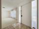 Entryway featuring tile flooring and a white front door leading into a carpeted living space at 13725 Oak Forest N Blvd, Seminole, FL 33776
