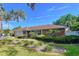 Charming single-story home featuring stone accents, lush landscaping, and a well-maintained lawn at 13725 Oak Forest N Blvd, Seminole, FL 33776