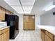 Bright kitchen with a black refrigerator and a skylight at 13725 Oak Forest N Blvd, Seminole, FL 33776