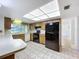 Bright kitchen with a black refrigerator and a breakfast bar at 13725 Oak Forest N Blvd, Seminole, FL 33776