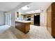 This kitchen has black appliances, tile flooring, a breakfast bar, and a view of the rest of the house at 13725 Oak Forest N Blvd, Seminole, FL 33776