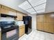 Cozy kitchen featuring black appliances and cabinetry at 13725 Oak Forest N Blvd, Seminole, FL 33776
