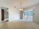 The living room features a sliding glass door to the patio and open access to other areas of the house at 13725 Oak Forest N Blvd, Seminole, FL 33776