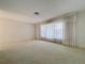 Expansive living room with carpeted floors, large windows, and neutral decor ready for customization at 13725 Oak Forest N Blvd, Seminole, FL 33776