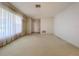 Bright living room featuring carpet flooring, sheer window treatments, and easy access to other rooms at 13725 Oak Forest N Blvd, Seminole, FL 33776
