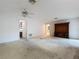 The living room features a ceiling fan, an entertainment center, and a doorway to a room with carpet at 13725 Oak Forest N Blvd, Seminole, FL 33776