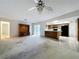 Spacious living room featuring an entertainment center, an open kitchen, and access to the outside patio at 13725 Oak Forest N Blvd, Seminole, FL 33776