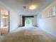 Bright living room with sliding glass doors leading to the backyard, carpet flooring, and window at 13725 Oak Forest N Blvd, Seminole, FL 33776
