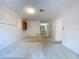 Bright living room with neutral walls, carpet flooring, and access to the bathroom and closet at 13725 Oak Forest N Blvd, Seminole, FL 33776