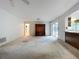 The spacious living room features a ceiling fan, an entertainment center, and access to the kitchen and outside at 13725 Oak Forest N Blvd, Seminole, FL 33776