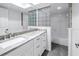 Modern bathroom showcasing the granite countertop vanity, tile floors, and shower at 13898 Egret Ln, Clearwater, FL 33762