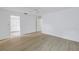 A bedroom featuring wood floors, neutral walls, and closet access at 13898 Egret Ln, Clearwater, FL 33762