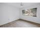 Neutral bedroom with ceiling fan and large window with backyard views at 13898 Egret Ln, Clearwater, FL 33762