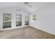 Bright bedroom with multiple windows, vaulted ceiling, and wood flooring at 13898 Egret Ln, Clearwater, FL 33762