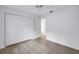 Clean bedroom featuring luxury vinyl floors, closet and views into the hallway at 13898 Egret Ln, Clearwater, FL 33762