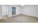 Bright bedroom boasts wood floors, a window with blinds, and a neutral color scheme at 13898 Egret Ln, Clearwater, FL 33762
