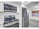 A modern kitchen featuring stainless steel appliances, white cabinets and countertops, and tile floors at 13898 Egret Ln, Clearwater, FL 33762