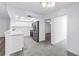 Modern kitchen features stainless steel appliances, white cabinets, and tile flooring at 13898 Egret Ln, Clearwater, FL 33762