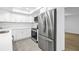 Bright kitchen features white cabinets, stainless steel appliances, and tile flooring at 13898 Egret Ln, Clearwater, FL 33762
