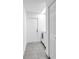 Bright laundry room with tile flooring, access door, and a modern washing machine for convenient laundry care at 13898 Egret Ln, Clearwater, FL 33762