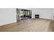 Spacious living room with wood floors, fireplace, and access to the screened-in porch at 13898 Egret Ln, Clearwater, FL 33762