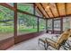 Enclosed porch features a wood plank ceiling and peaceful lake views at 13898 Egret Ln, Clearwater, FL 33762