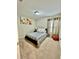 Cozy bedroom with a queen-sized bed, carpeted floors, and a large window for natural light at 14015 Arbor Pines Dr, Riverview, FL 33579