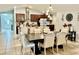 Elegant dining area featuring a large wooden table and stylish upholstered chairs at 14015 Arbor Pines Dr, Riverview, FL 33579