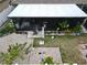 View from above showing an enclosed patio with a lush backyard area with gravel, plants, and greenery at 14015 Arbor Pines Dr, Riverview, FL 33579