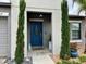 Inviting entryway with a classic blue door and charming plants at 14015 Arbor Pines Dr, Riverview, FL 33579