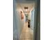 Hallway with tiled floor, neutral walls, and artwork at 14015 Arbor Pines Dr, Riverview, FL 33579