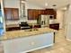 This kitchen features granite counters, stainless steel appliances, dark wood cabinets, and a large island with a sink at 14015 Arbor Pines Dr, Riverview, FL 33579