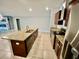 A kitchen island with granite countertops and a stainless steel sink complements the stainless steel appliances and granite countertops at 14015 Arbor Pines Dr, Riverview, FL 33579