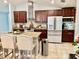 Modern kitchen with granite countertops, brown cabinets, and stainless steel appliances at 14015 Arbor Pines Dr, Riverview, FL 33579