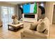 Cozy living room with a fireplace, large TV, and comfortable seating at 14015 Arbor Pines Dr, Riverview, FL 33579