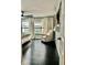The bright living room features dark floors, large windows, and comfortable seating with an entertainment center at 14015 Arbor Pines Dr, Riverview, FL 33579