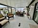 Enclosed patio featuring comfortable seating, a ceiling fan, an outdoor kitchen, and views of the backyard at 14015 Arbor Pines Dr, Riverview, FL 33579