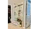 Modern walk-in shower featuring beautiful marble walls, a sliding glass door, and sleek black hardware at 14015 Arbor Pines Dr, Riverview, FL 33579