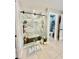 Well-lit shower with marble-style walls, glass door, rainfall showerhead, and a small seat in the corner at 14015 Arbor Pines Dr, Riverview, FL 33579