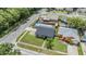 Nice neighborhood aerial view showcasing a light gray home with fenced in backyard pool and green front lawn at 16023 Splitlog Dr, Tampa, FL 33618