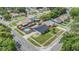 Charming neighborhood aerial view showcasing a gray home with a pool in a fenced backyard at 16023 Splitlog Dr, Tampa, FL 33618