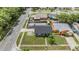 A high angle view of a light gray house with a fenced in backyard pool and well-kept lawn at 16023 Splitlog Dr, Tampa, FL 33618