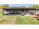 Screened-in patio with access to the grassy backyard, great for outdoor gatherings at 16023 Splitlog Dr, Tampa, FL 33618