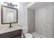 Modern bathroom with stylish vanity, toilet, and tiled walk-in shower with glass enclosure at 16023 Splitlog Dr, Tampa, FL 33618