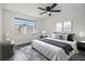 Cozy bedroom with neutral decor, natural light, ceiling fan and wood laminate flooring at 16023 Splitlog Dr, Tampa, FL 33618