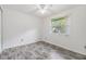 Bedroom with gray laminate flooring, natural light, and ceiling fan at 16023 Splitlog Dr, Tampa, FL 33618