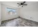 Bedroom with laminate flooring, ceiling fan, and natural light at 16023 Splitlog Dr, Tampa, FL 33618