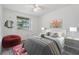 Inviting bedroom with a comfortable bed, bright window, and colorful decor at 16023 Splitlog Dr, Tampa, FL 33618
