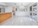 Open dining area with tiled floors, sliding glass doors to the patio, and breakfast bar at 16023 Splitlog Dr, Tampa, FL 33618