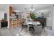 Dining room with marble table set, mirrored wall and bar stool kitchen pass through at 16023 Splitlog Dr, Tampa, FL 33618